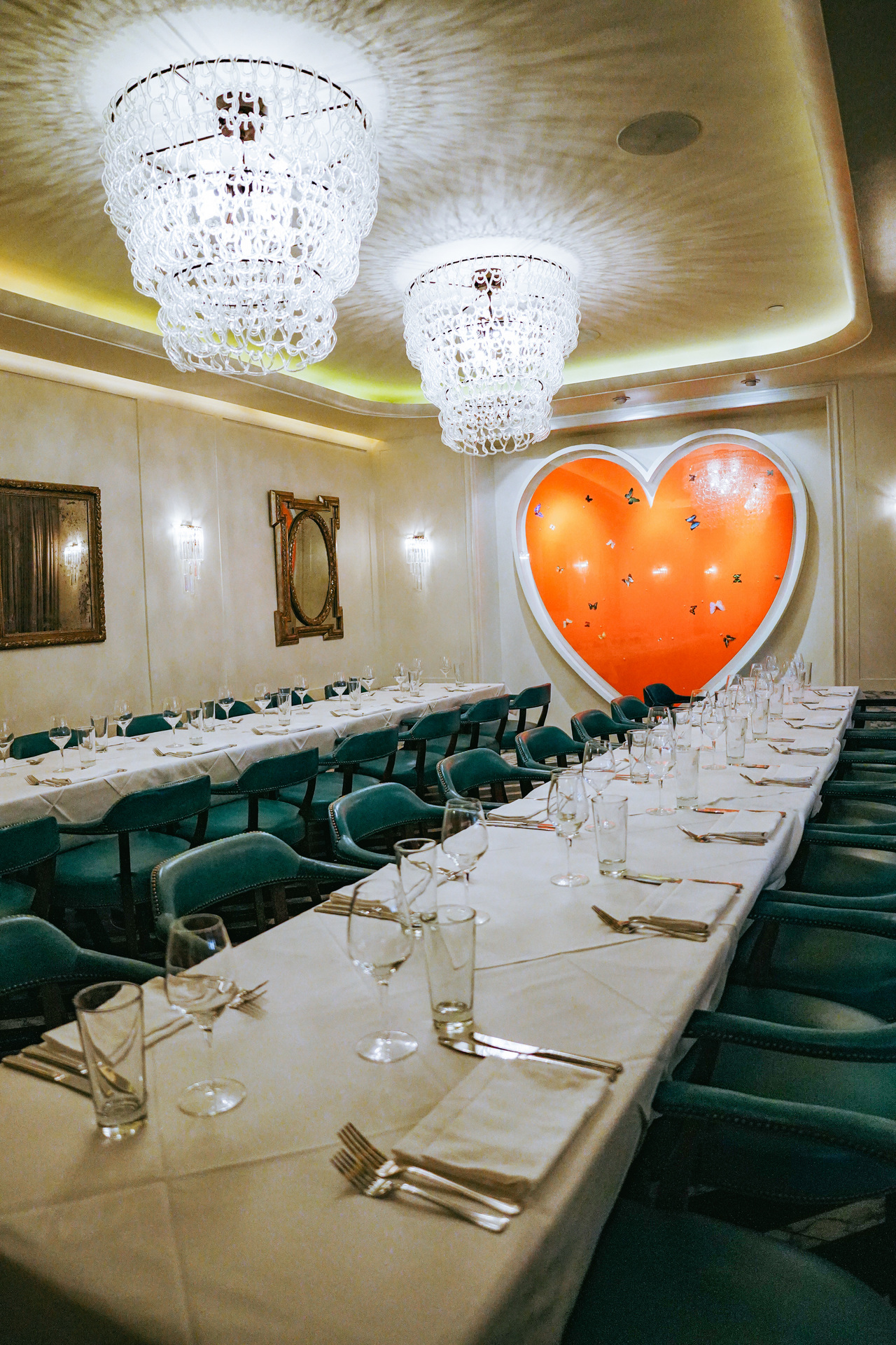 Two long dining tables with a giant painting of a heart